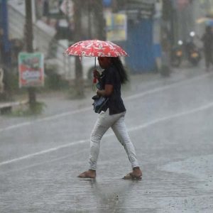 A woman uses an umbrella as she walks during a heavy downpour in Colombo on May 26, 2017.
The Sri Lankan capital has been lashed by heavy rains causing major traffic jams throughout the city. / AFP PHOTO / Ishara S. KODIKARA